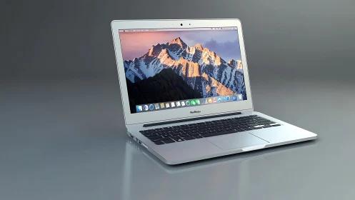 Sleek silver laptop stands open against a smooth grey backdrop