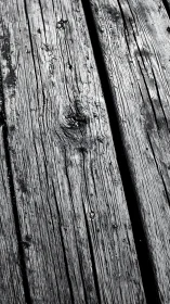 Weathered timber whispers in monochrome grain and shadow.
