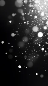 Monochrome bokeh particle field on dark gradient background.