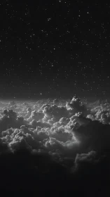 Midnight clouds drifting beneath a quiet starry sky.