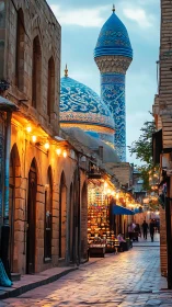 Bazaar alley frames ornate blue mosque at twilight.