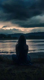 Storm-brewing dusk watched by a riverside silhouette dreamer.