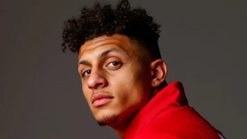 Studio portrait of young man in red sportswear under soft light
