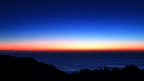 Twilight horizon melting neon dusk into deep sapphire sea.