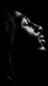 Side-lit serenity carves a luminous portrait from darkness.