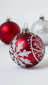 Sparkling red Christmas baubles share gentle holiday cheer
