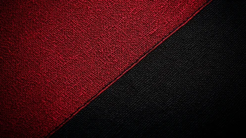 Diagonal division of red and black woven textile surface.