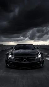 Stormy rooftop showdown with a sleek black Mercedes coupe.