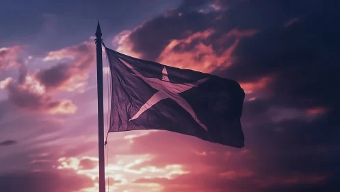 Star flag silhouette against vivid sunset sky clouds.