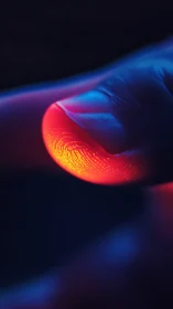 Glowing fingertip rests in neon light, revealing vivid texture