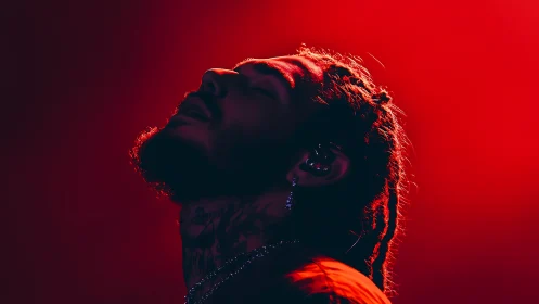 Backlit vocalist in saturated red stage wash and side profile