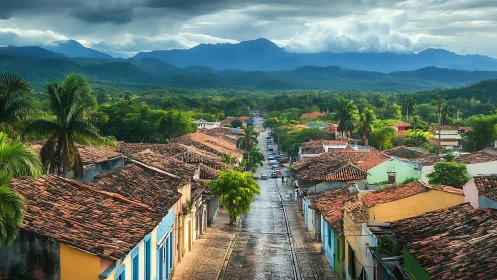 Colonial street leads into lush valley under storm clouds.