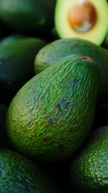 Richly textured avocado close-up under soft market light.