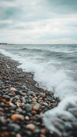 Gentle waves kissing a rocky shoreline under soft skies.