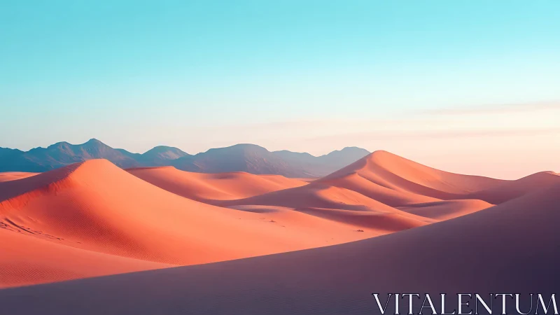 Sunlit desert dunes with distant violet mountains at dawn.