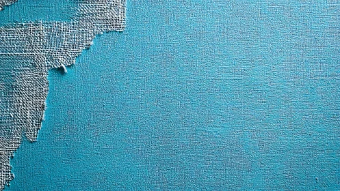 Textural blue wall with frayed fabric edge, minimal abstract study.