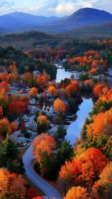 Lakeside village glows under dense autumn mountain forest.