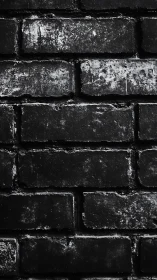 Dark weathered brick wall texture in close-up view.