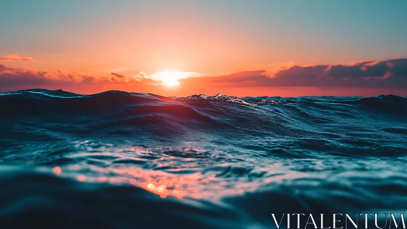 Wide-angle ocean swells under saturated sunset horizon glow.