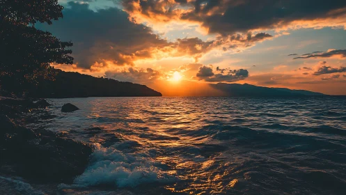 Coastal shoreline and distant hills under low sun horizon.