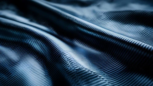 Textured blue metallic surface shows wave-like microstructured ridges