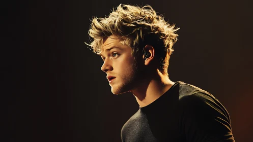 Golden-lit singer pauses mid-note in cinematic profile glow.