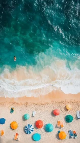 Aerial coastal panorama with sunbathers, umbrellas and shore break