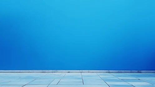 Blue wall meets tiled ground in a minimal urban scene