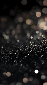 Dark glitter background with soft bokeh light circles.