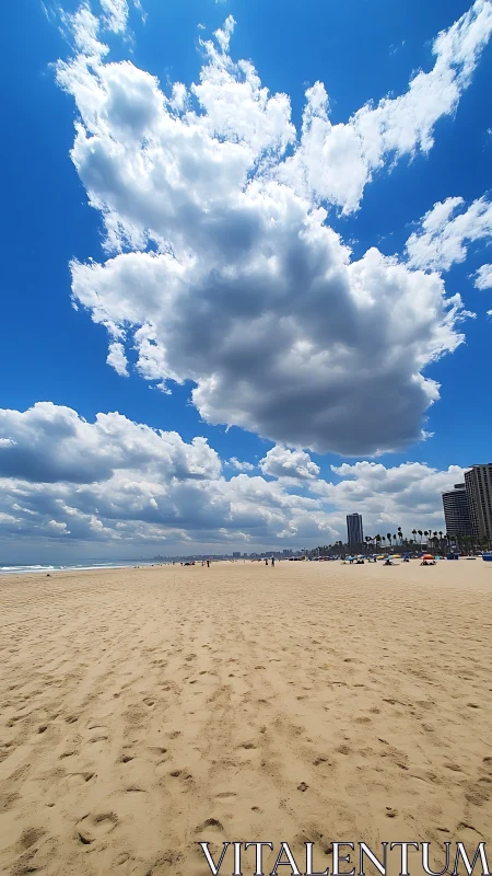 Clouds build above wide sandy beach with distant cityline