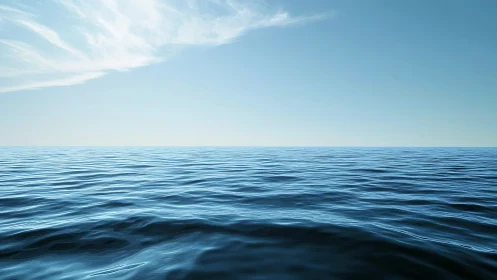 Calm open ocean horizon under clear blue daytime sky.