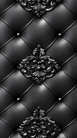 Ornamental black tufted surface with metallic baroque medallions.