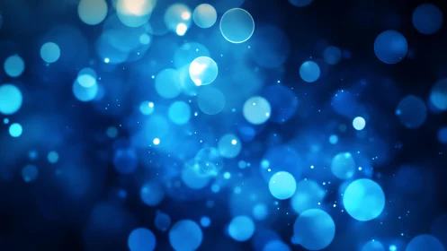 Abstract blue bokeh lights background with glowing circles.