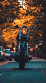 Motorcycle stands centered on urban street at sunset light