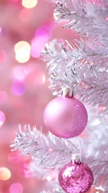 White artificial tree with pink matte and glitter ornaments