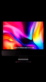 Ultrawide desktop monitor with vivid abstract gradient display.