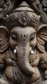 Stone Ganesha sculpture shows intricate carved ornament.