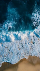 Aerial shoreline study with dynamic foamy wave structure.