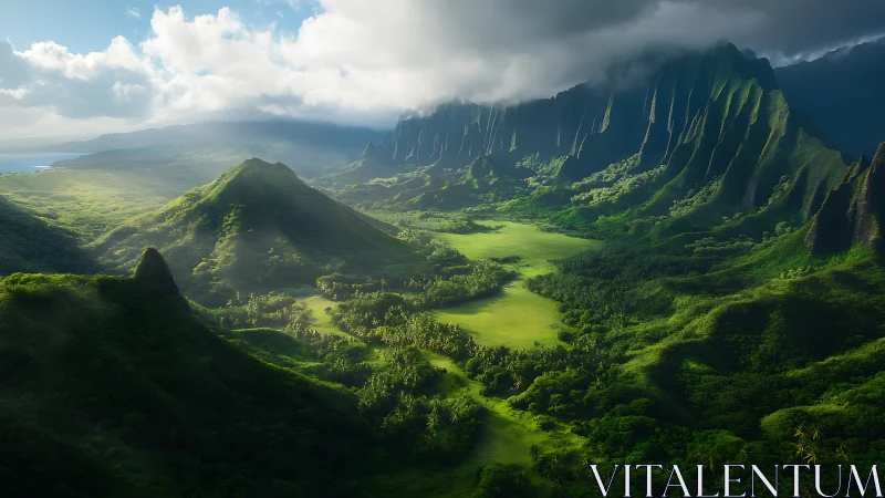 Sunlit emerald valley beneath towering cloud-kissed cliffs.