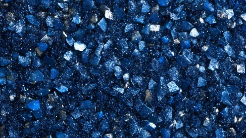 Deep blue crystal shards with glittering textured surface.