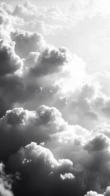 Monochrome cloudscape with layered sunlit formations.