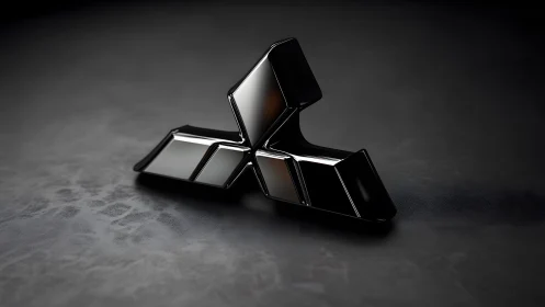 Sleek black metallic geometric emblem on dark textured surface.