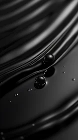 Glossy black liquid surface shows reflective droplets in motion