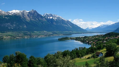Lakeside town sits below steep snowcapped mountain range