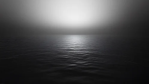 Minimalist horizon shows silver light over dark water.