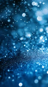 Macro bokeh of suspended blue water droplets in motion