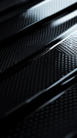 Carbon fiber surface shows glossy ridges and micro texture.