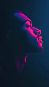Side profile portrait shows man in pink and blue neon light