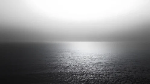 Monochrome seascape shows tonal gradient sky over calm horizon