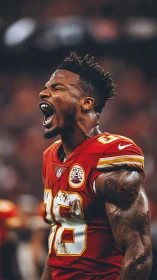 American football player in red jersey shouting on field.